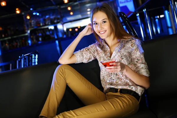 Attractive woman in night club with a drink — Stock Photo, Image