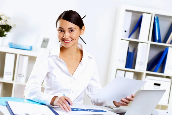 Jonge vrouw in zakelijke slijtage in office — Stockfoto