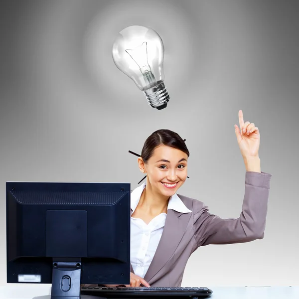 Businesswoman at workplace and money symbols — Stock Photo, Image