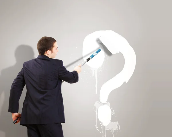 Businessman with paint brash and question mark — Stock Photo, Image