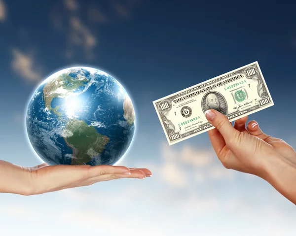 stock image Human hands holding money against blue sky