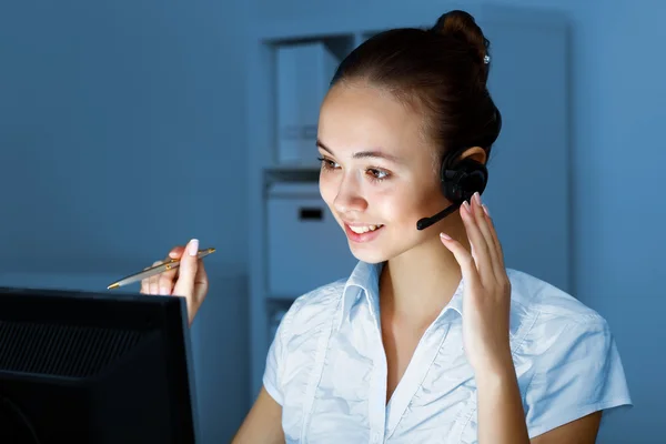 Young woman in business wear and headset — Stock Photo, Image