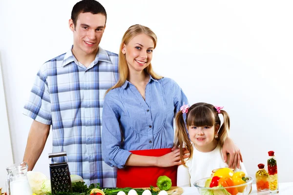 Family with a daughter cooking together at home — Stock Photo, Image