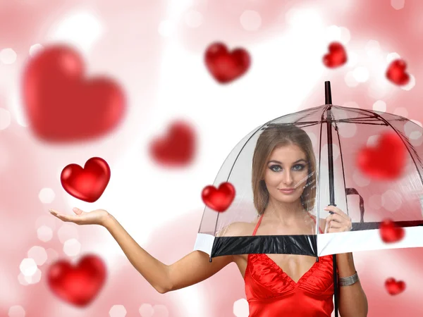 Mooie jonge vrouw met paraplu en harten — Stockfoto