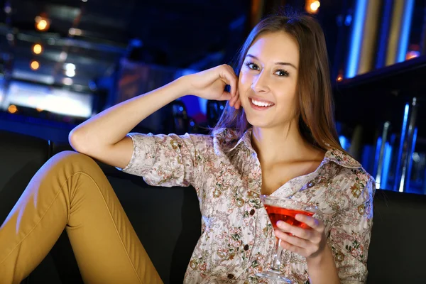 Attractive woman in night club with a drink Stock Image