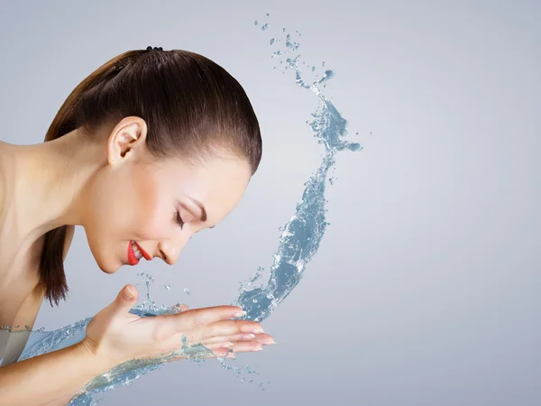Young woman with water splashes — Stock Photo, Image