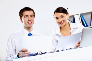 Two young business collegue in office clipart