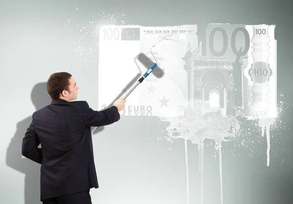 Businessman with a paint brush and banknote — Stock Photo, Image