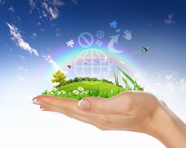 Human hand holding a green landscape — Stock Photo, Image