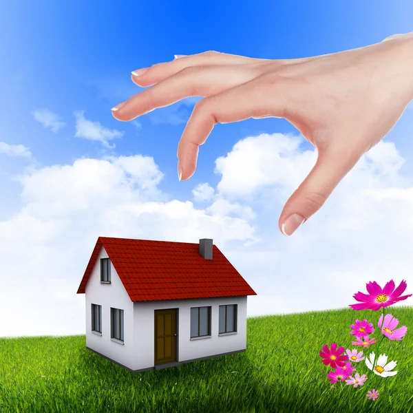 Casa y mano humana contra el cielo azul —  Fotos de Stock