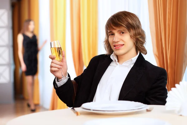 stock image Young handsome man sitting in restaurant