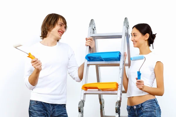 stock image Young couple with paint brushes together