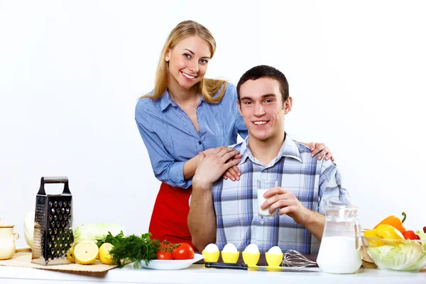 Husband and wife together coooking at home Stock Picture