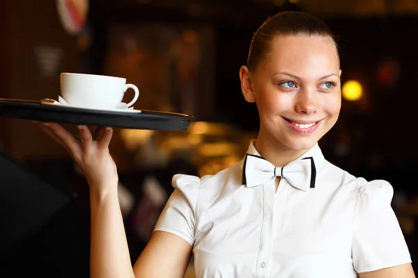 stock image Portrait of young waitress holding a tray