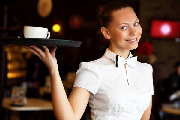 Portrait of young waitress holding a tray — Stock Photo, Image