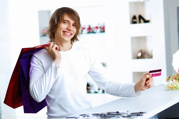 Stock image Young man doing shopping