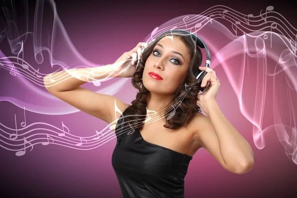 Young woman in evening dress with headphones — Stock Photo, Image