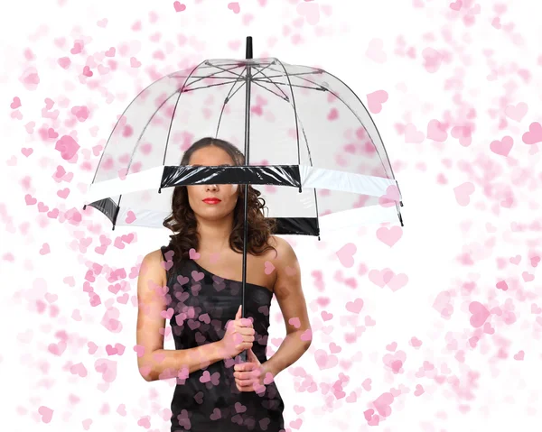 Mooie vrouw onder paraplu met bloemblaadjes om haar heen — Stockfoto