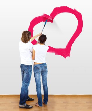 Young couple with paint brushes clipart