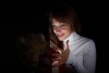 Young woman reading a magic book