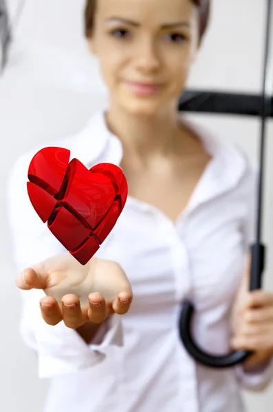 Woman with a red heart in her hand — Stock Photo, Image