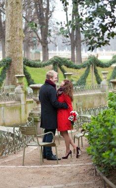 Romantic couple in love having a date in the Luxembourg garden clipart