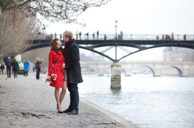 Romantic couple in love dating near Pont des Arts in Paris clipart
