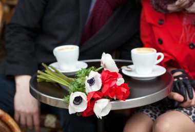 Dating couple in a Parisian cafe clipart