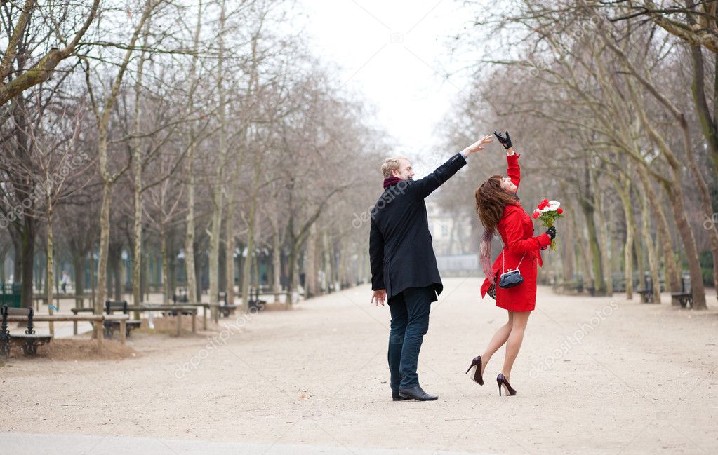 Happy couple dancing in the Luxembourg garden of Paris