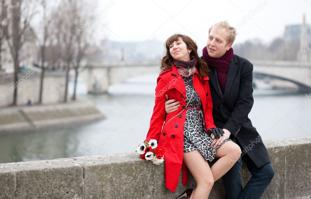 Dating couple at the Parisian embankment at misty day