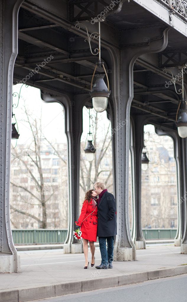 Romantic couple kissing on the Bir-Hakeim bridge