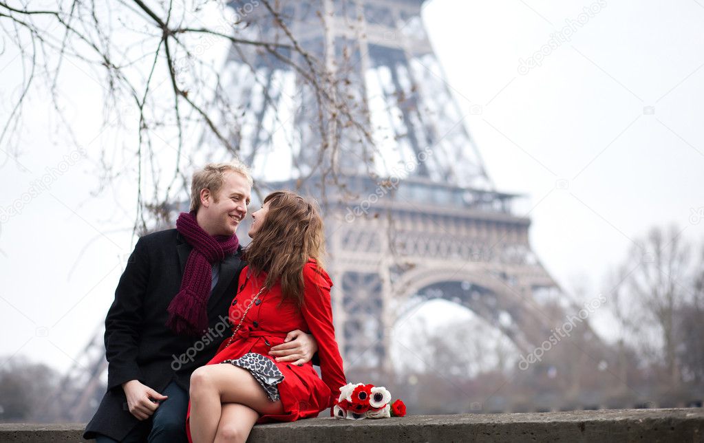 Romantic couple in love dating near the Eiffel Tower at spring o