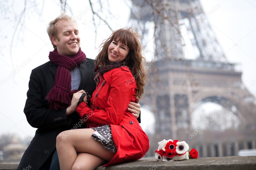 Happy couple in love dating near the Eiffel Tower at spring or a