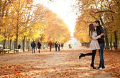 Young beautiful couple in the Luxembourg garden at fall