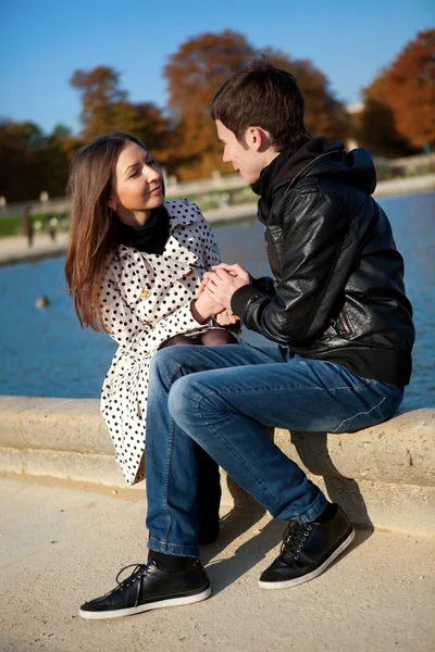 Young romantic couple near water at warm sunny autumn day — Stock Photo, Image