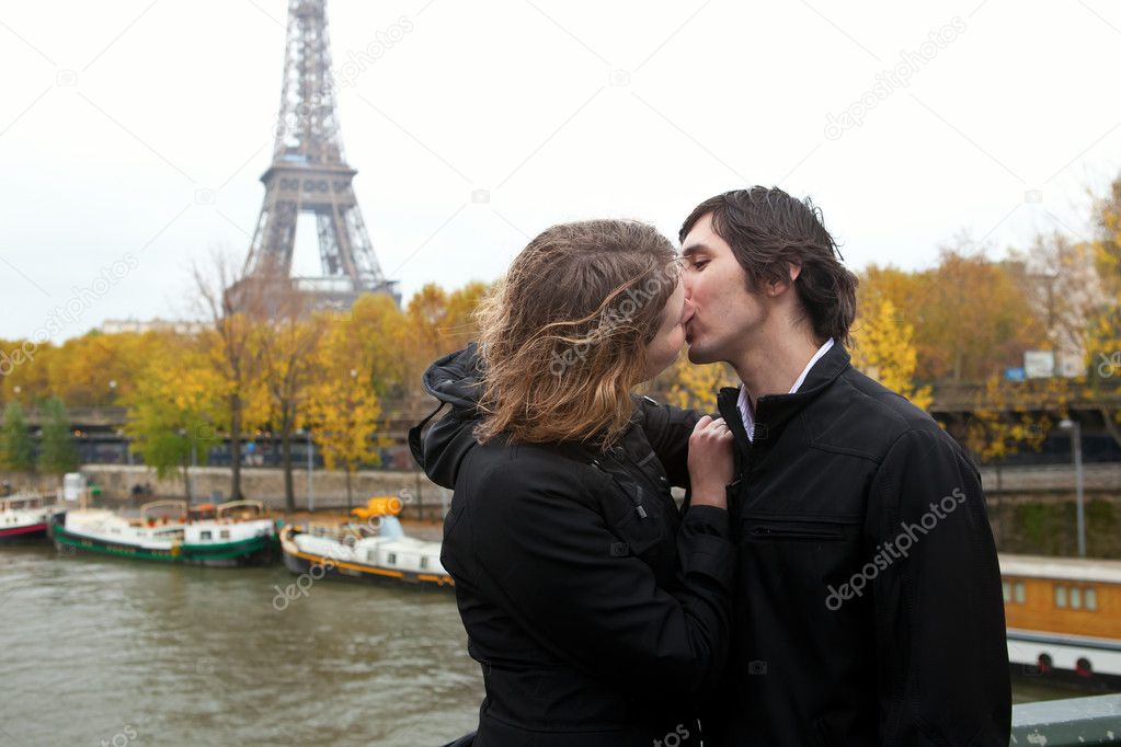 Couple in Paris, kissing at rain