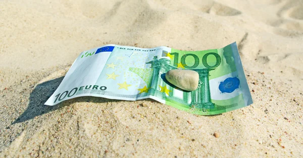 stock image Euro on sand.