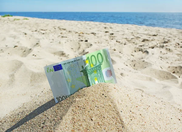 stock image Euro on the sand.