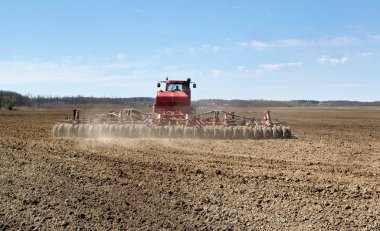 Red tractor working. clipart