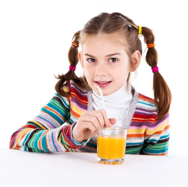 Маленькая девочка пьет апельсиновый сок — стоковое фото