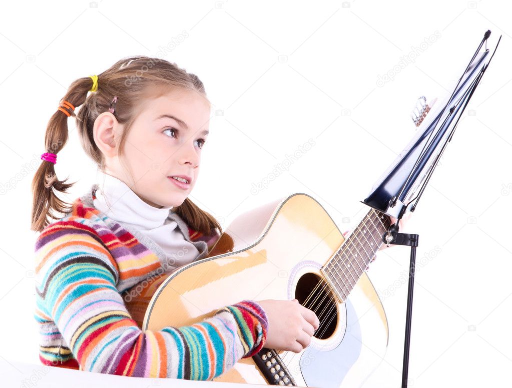 Girl playing acoustic guitar isolated on white