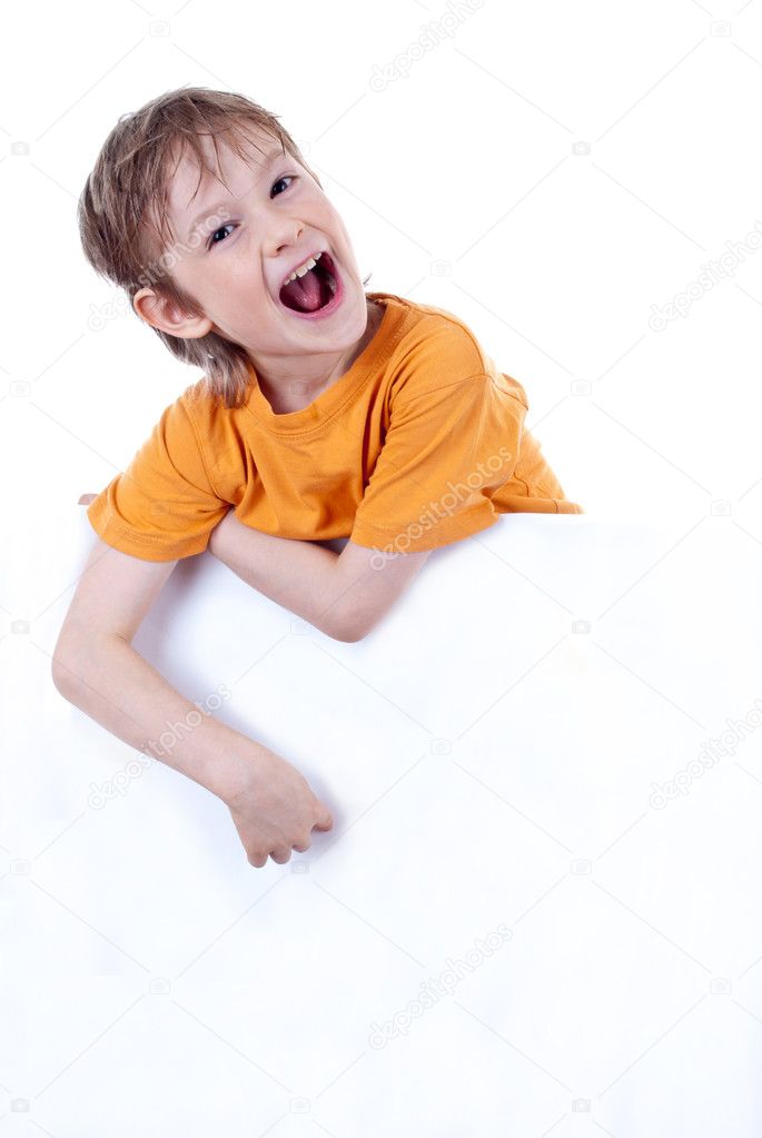 Portrait of a happy small boy holding a blank board