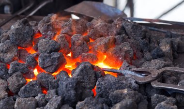 Forge with hot flaring coal clipart