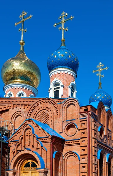 Cupolas of Russian orthodox church against blue sky