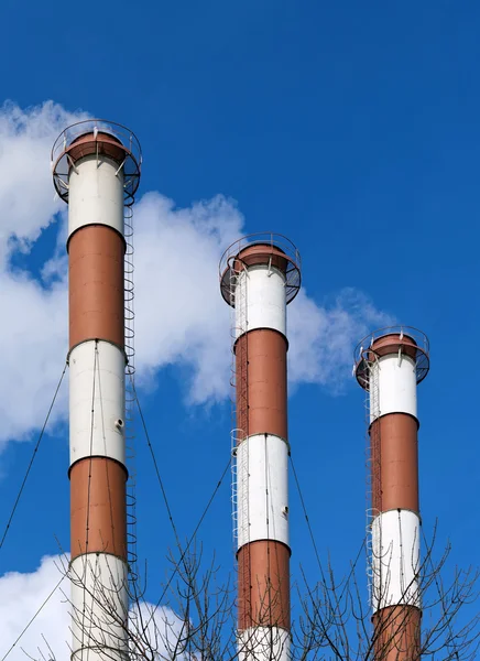 Lots of smoking chimneys other blue sky — Stock Photo, Image