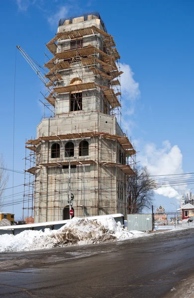 stock image Tower building under construction with crane over blue sky backg