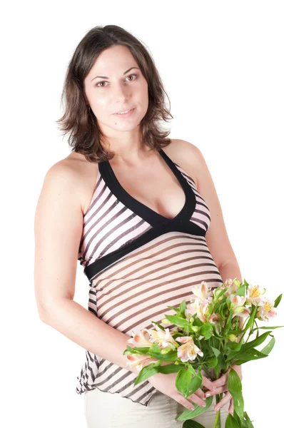 漂亮孕妇用鲜花的肖像 — 图库照片