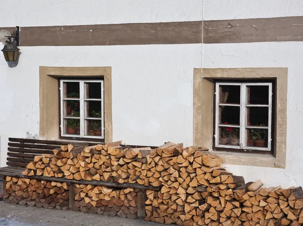 Firewood, stacked against the wall in the house — Stock Photo, Image