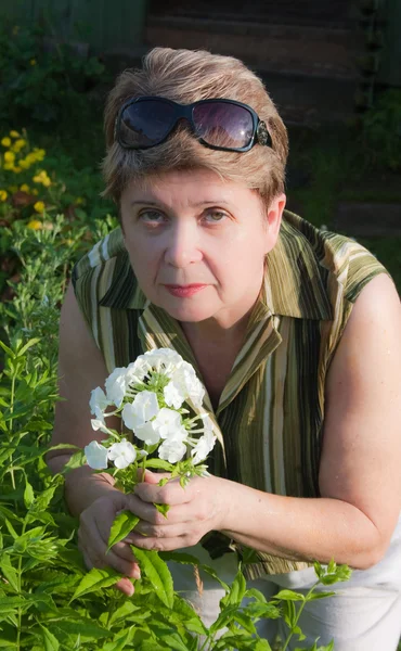 Çiçek açan phlox ile bir kadın portresi — Stok fotoğraf