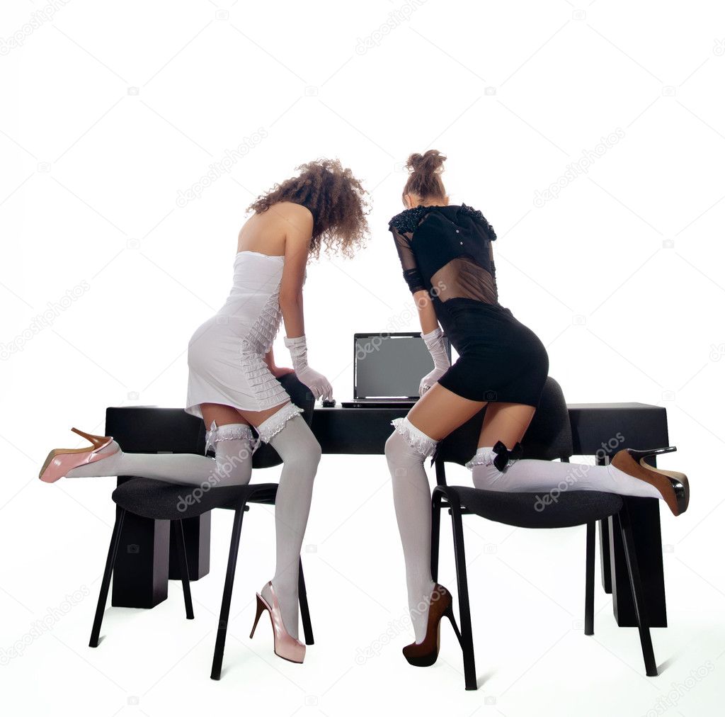 Sexy two women at office with a laptop